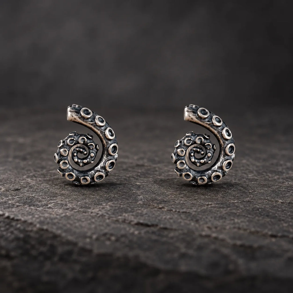 Pair of oxidized sterling silver coiled tentacle stud earrings shown from the front
