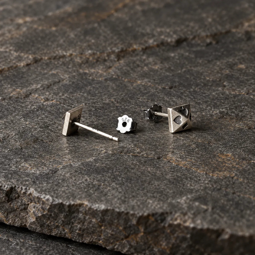 Back view of silver pyramid stud earrings showing straight posts and butterfly backs