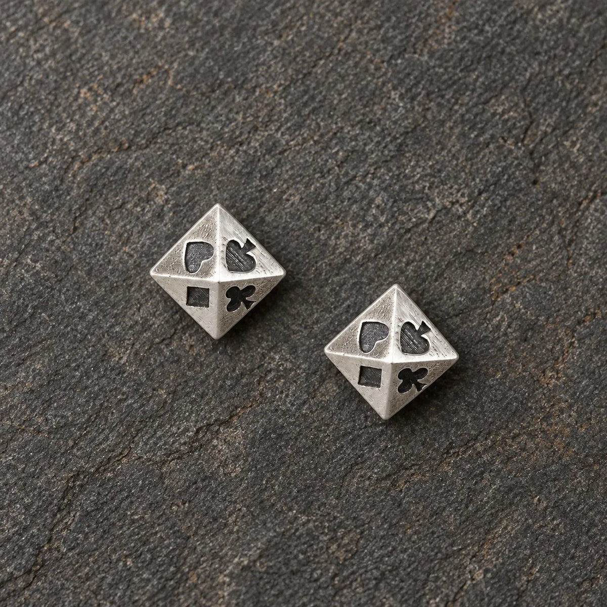 Pair of oxidized silver pyramid stud earrings featuring four playing card suits