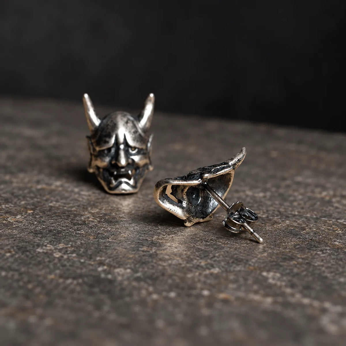 Front and back view of Hannya mask stud earrings showing the hollow back, post and butterfly closure