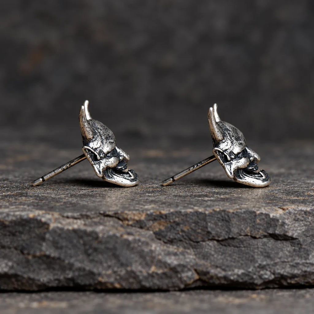 Side profile of Hannya mask stud earrings showing their sculptural depth and straight posts