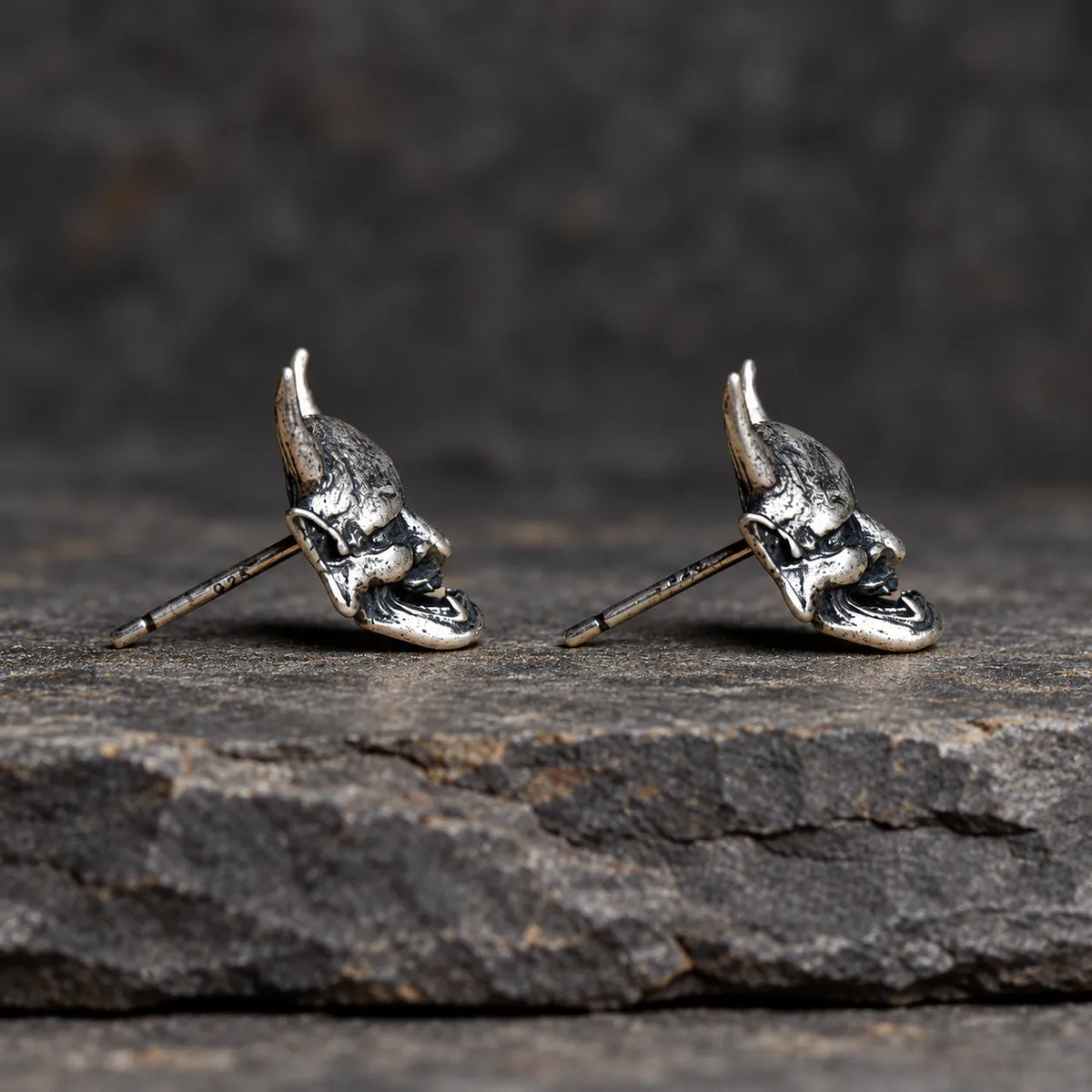 Side profile of Hannya mask stud earrings showing their sculptural depth and straight posts
