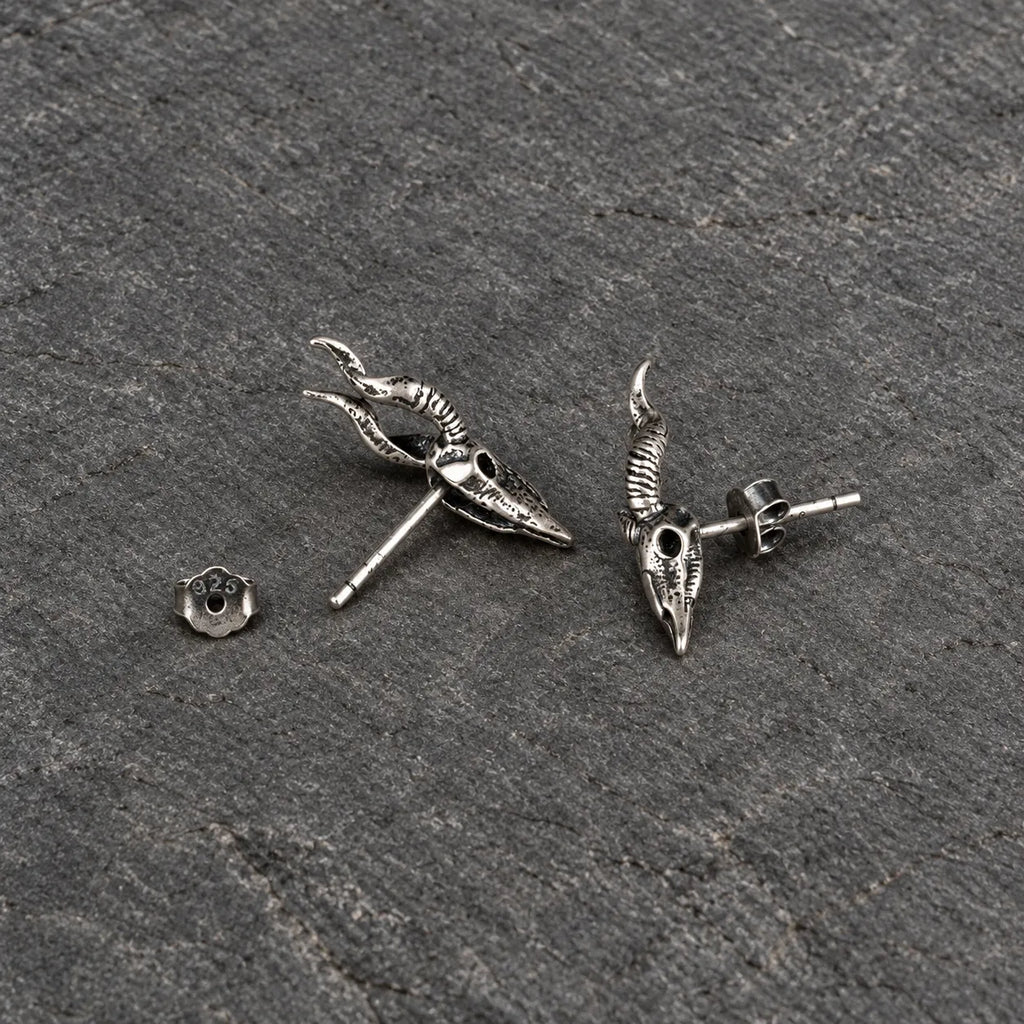Back and side view of horned skull stud earrings with straight posts and butterfly backs