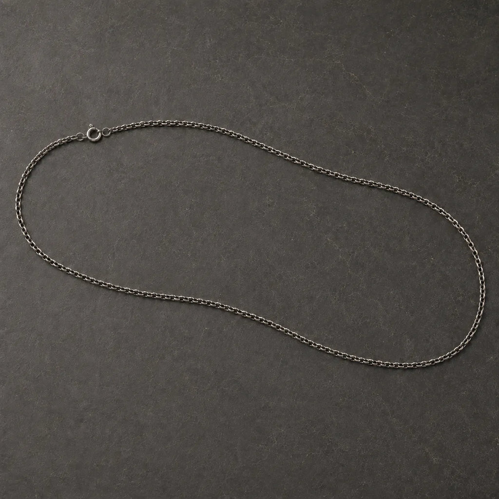 Full view of an oxidized 925 sterling silver cable chain with a round spring-ring clasp