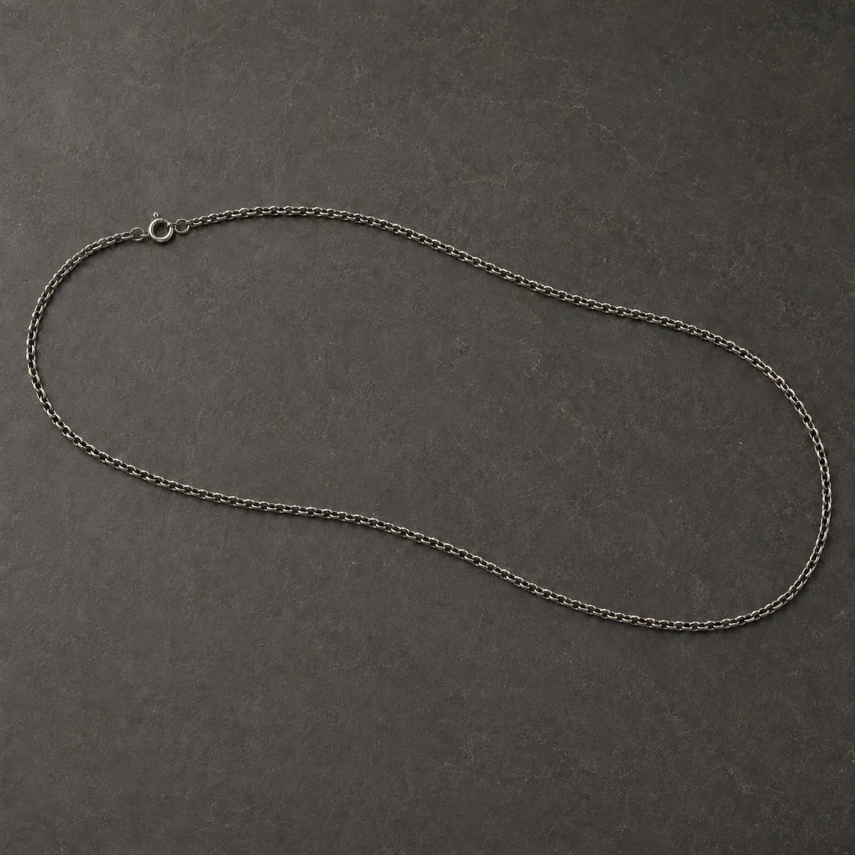 Full view of an oxidized 925 sterling silver cable chain with a round spring-ring clasp