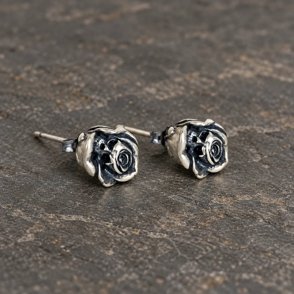 Angled view of sculpted rose stud earrings showing their posts and butterfly backs