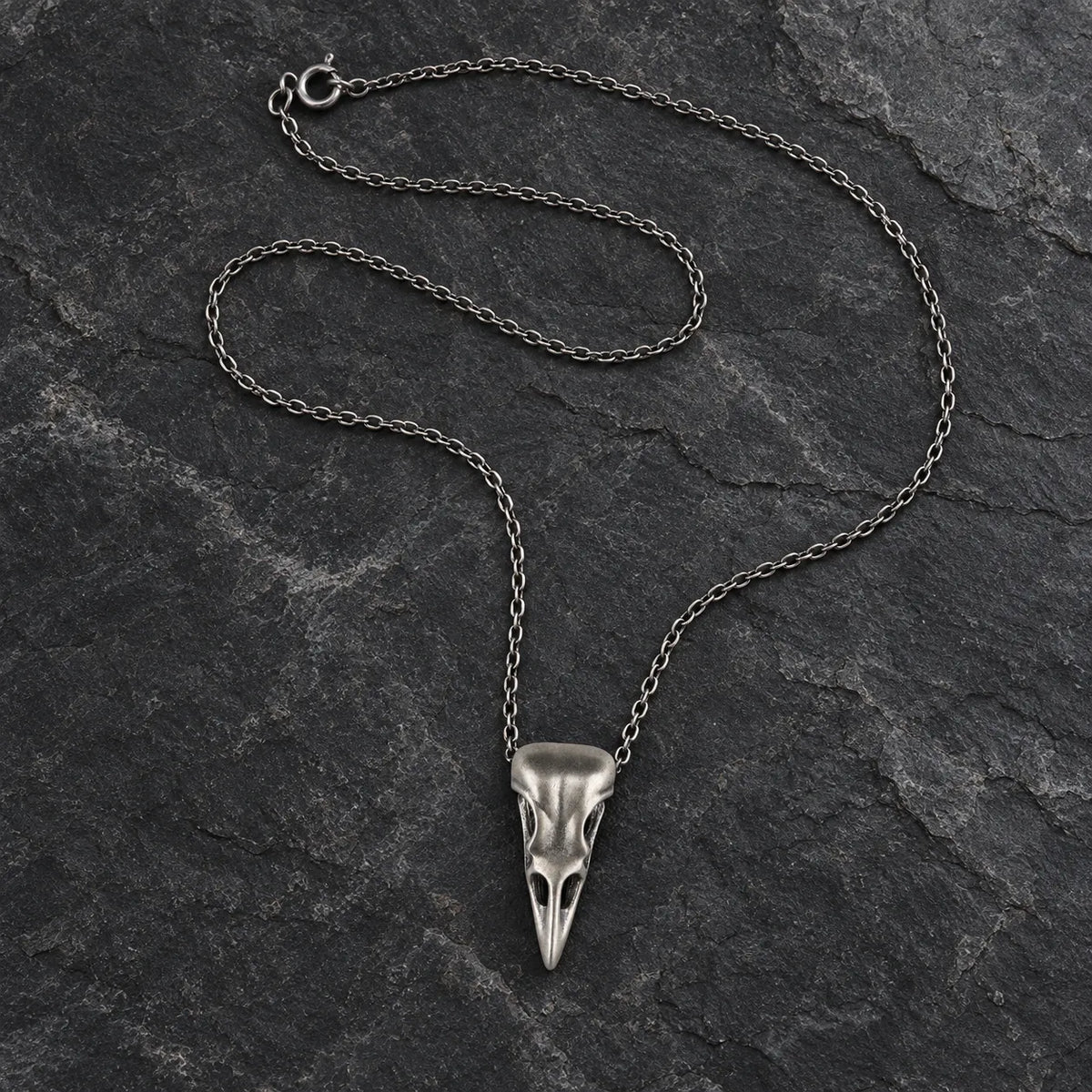 Oxidized silver raven skull pendant displayed with an optional 2.0 mm cable chain