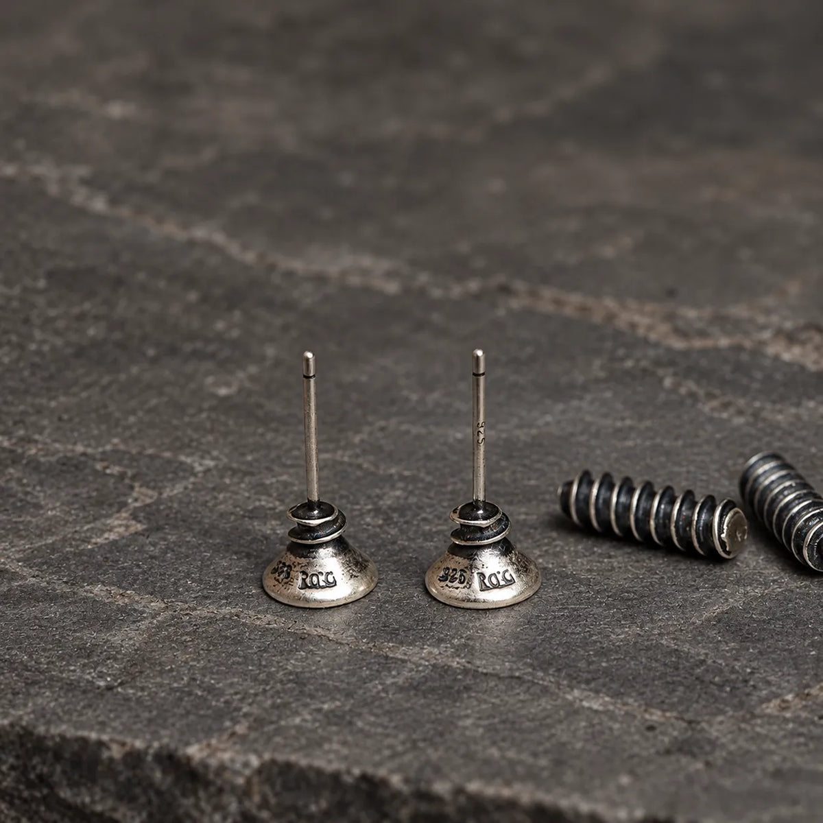 Back view of sterling silver screw stud earrings showing straight posts and detachable sculpted backs
