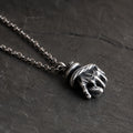 Low side angle of the serpent hand pendant showing its sculptural depth