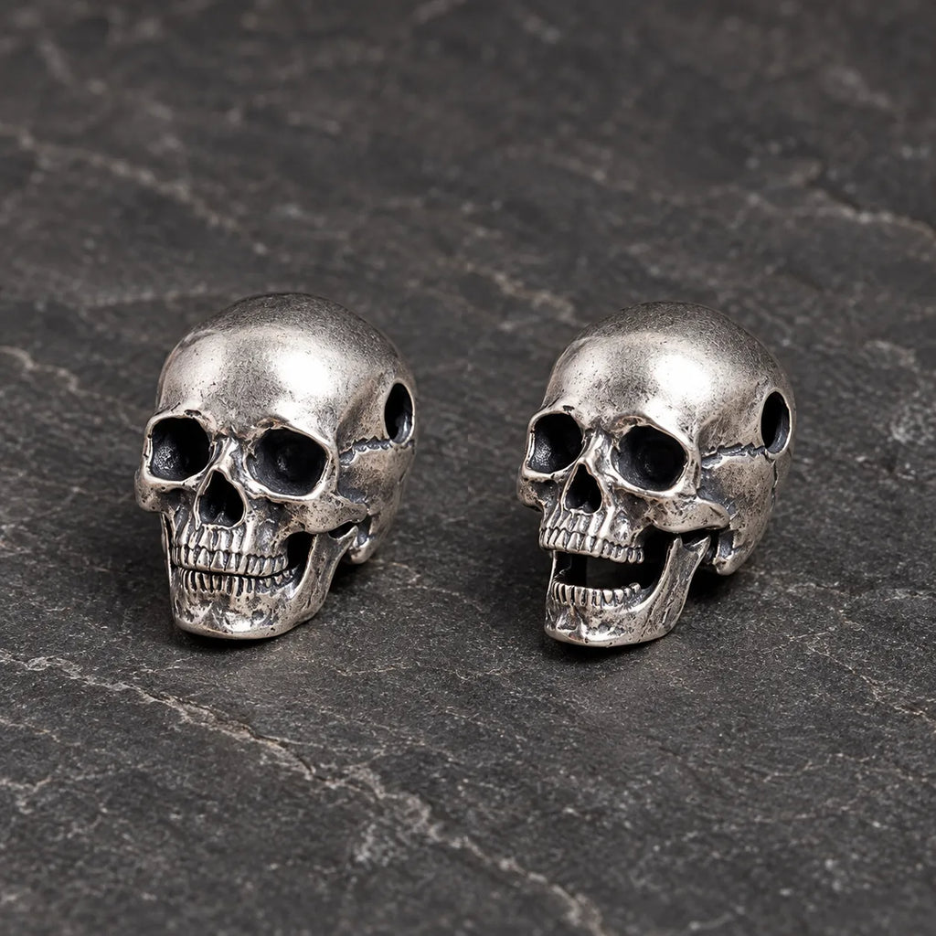 Articulated skull pendant shown with its movable jaw closed and open