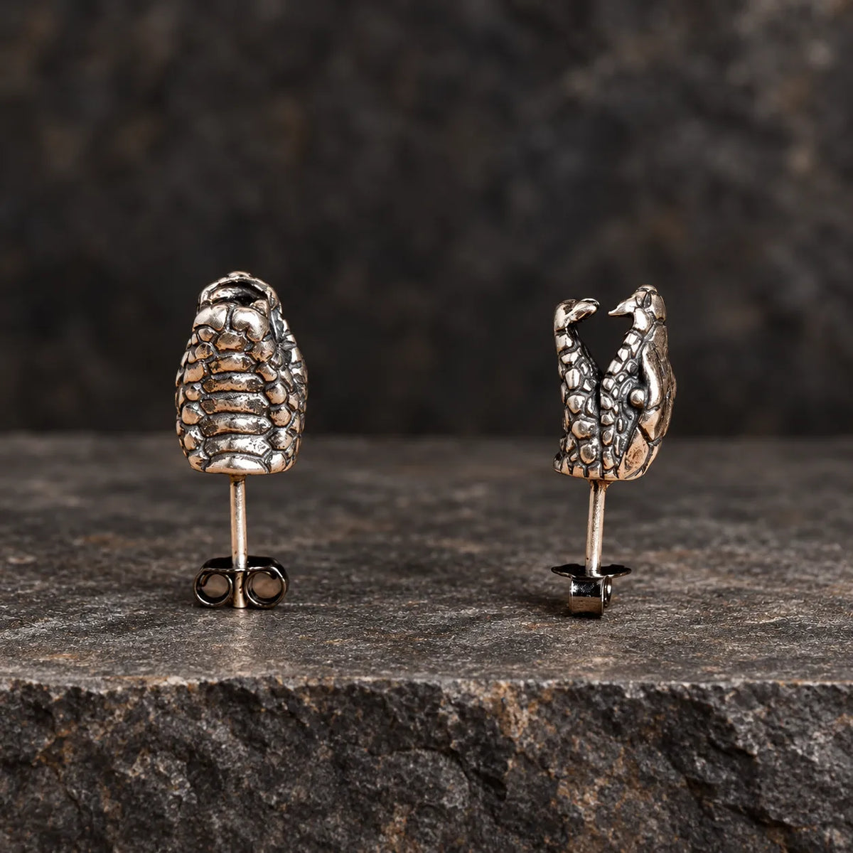 Underside and side-profile views of oxidized silver snake head stud earrings