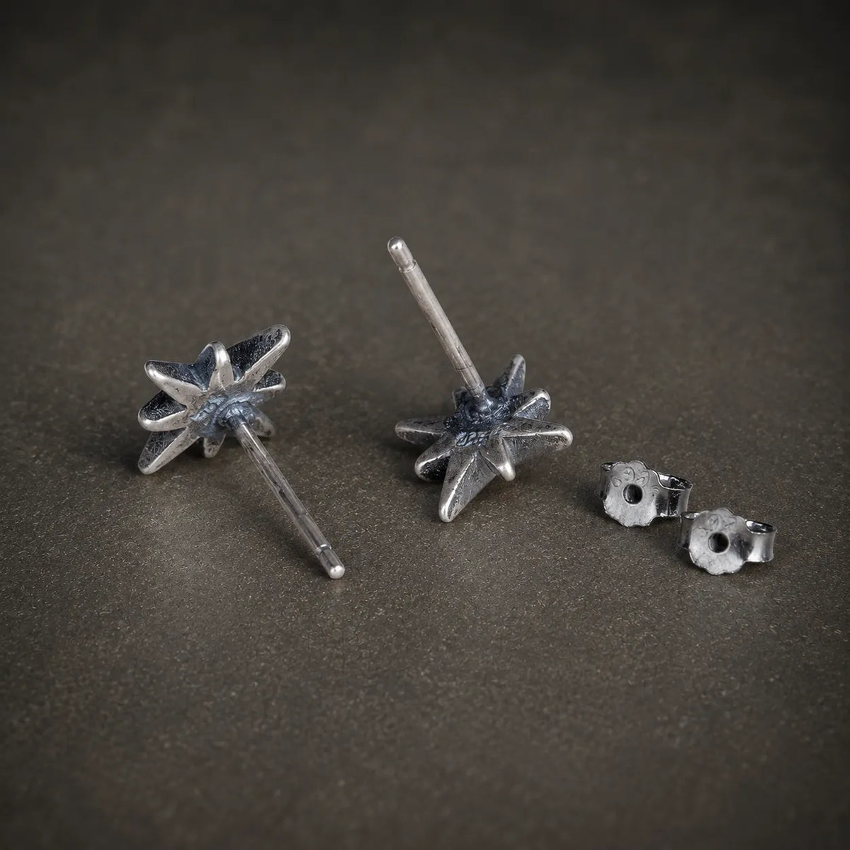 Back view of starburst stud earrings showing straight posts and butterfly backs