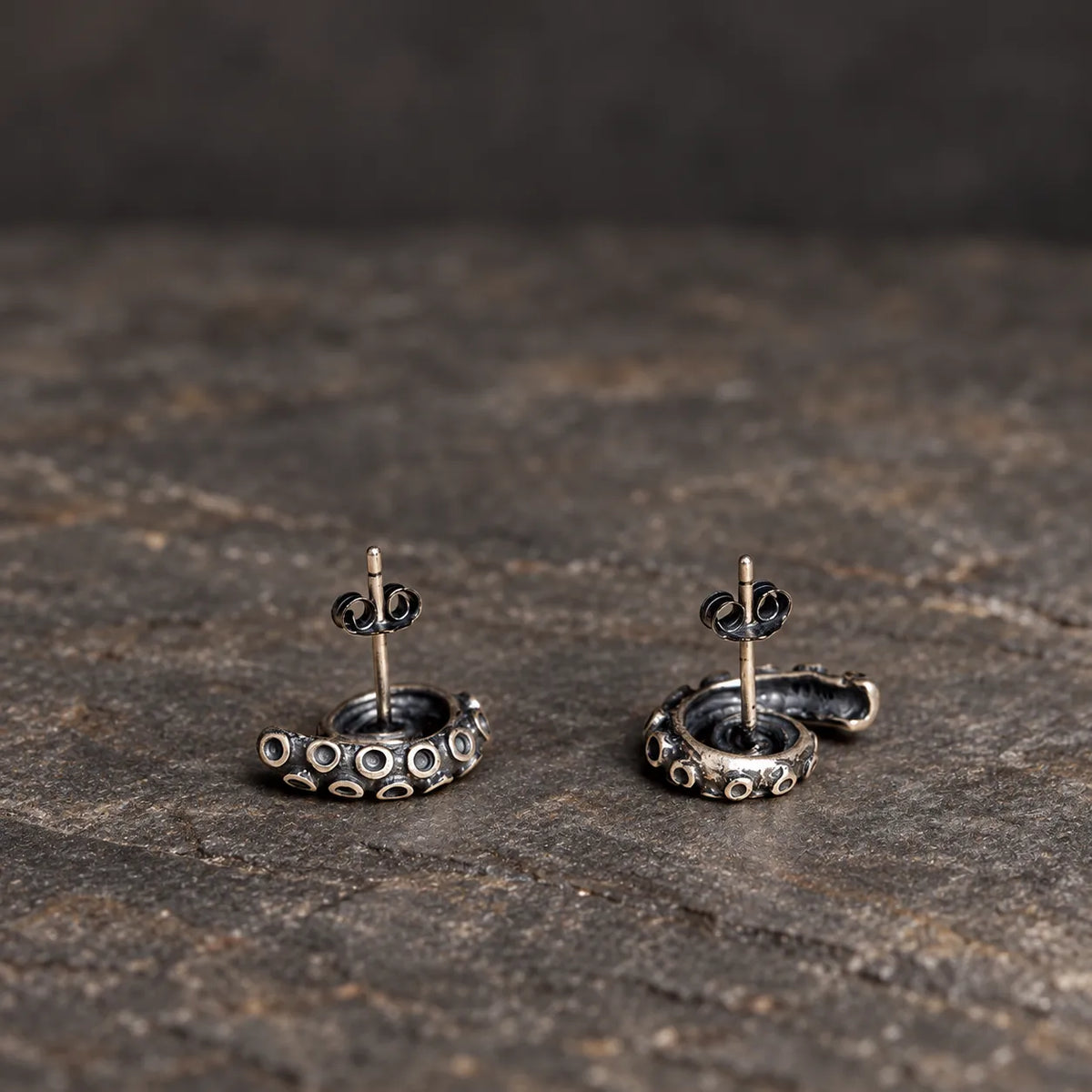 Back view of coiled tentacle stud earrings showing recessed backs and straight posts