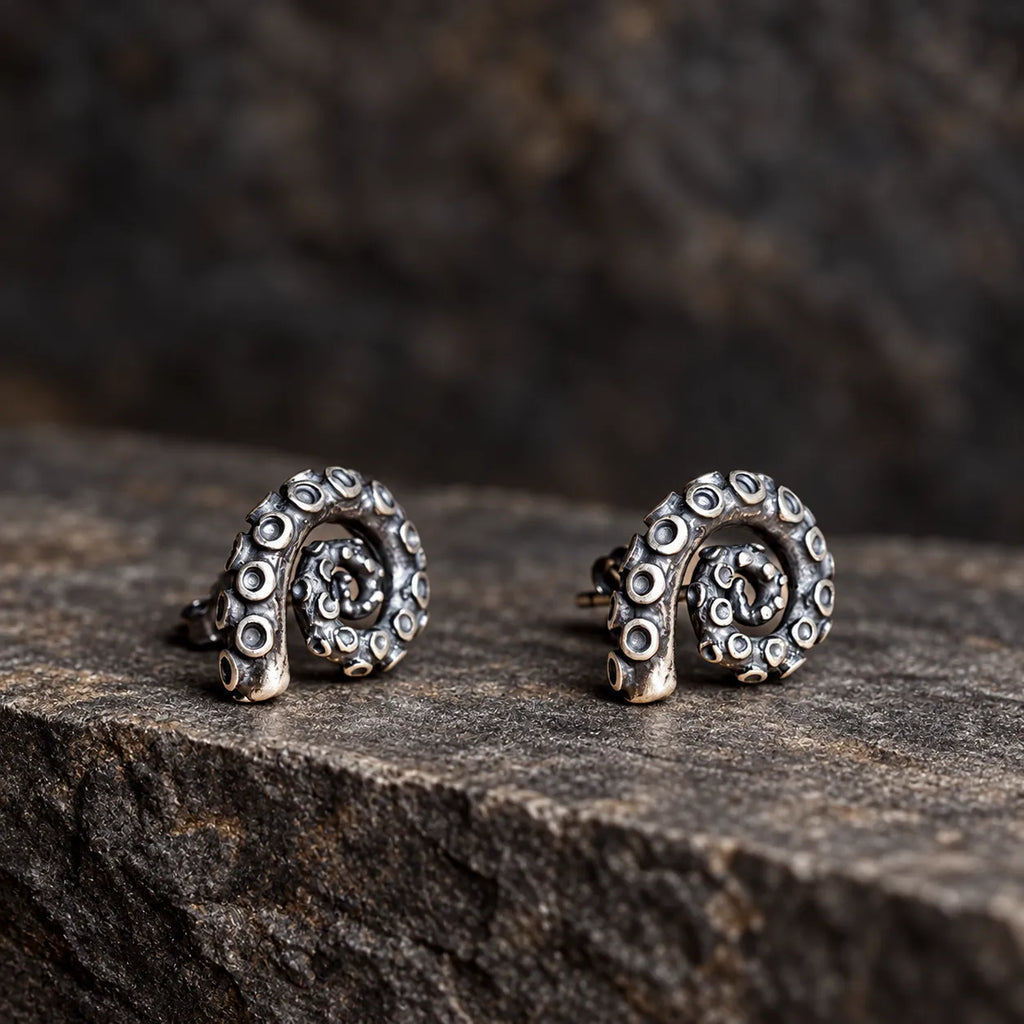 Low-angle view of coiled tentacle stud earrings showing their raised spiral construction