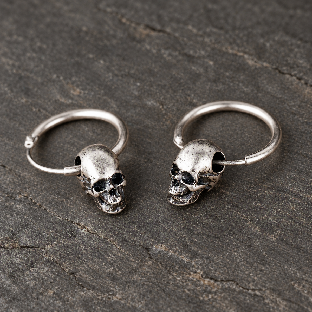 Low front view highlighting the sculpted skull faces and oxidized details