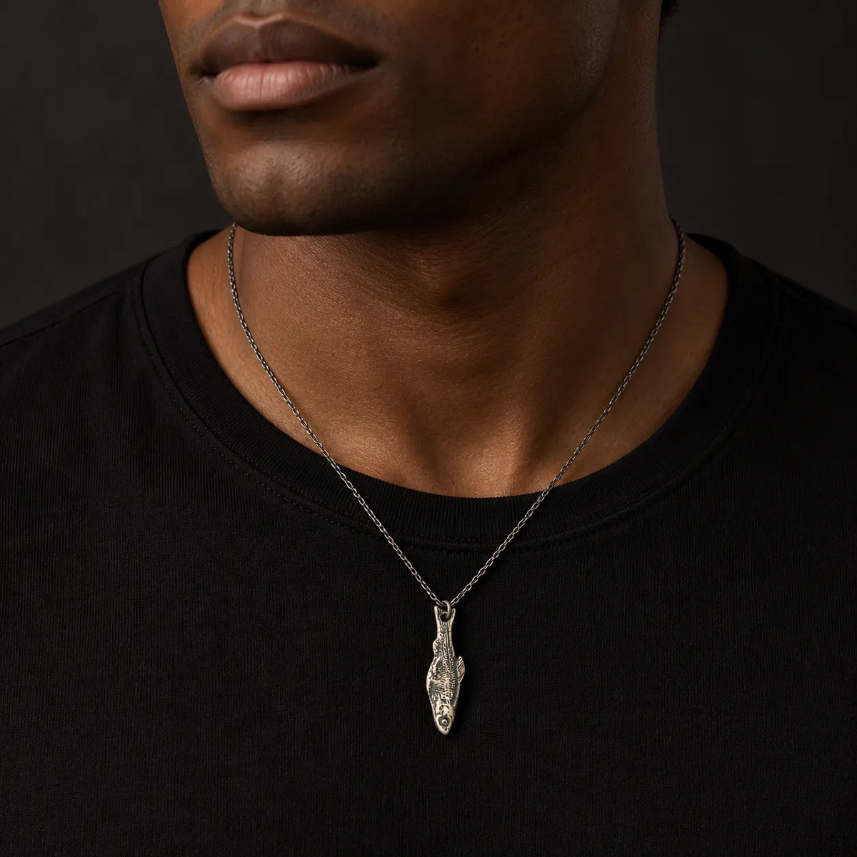 Undying fishbone pendant worn at its approximate 10 by 37 mm size on a 1.5 mm chain