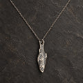 Front view of an oxidized 925 sterling silver fishbone pendant shown with an optional chain