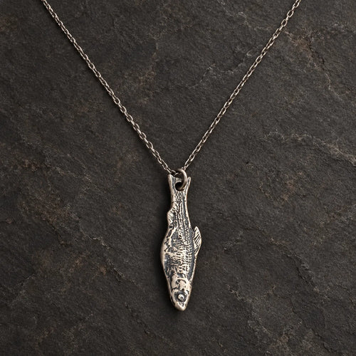 Front view of an oxidized 925 sterling silver fishbone pendant shown with an optional chain